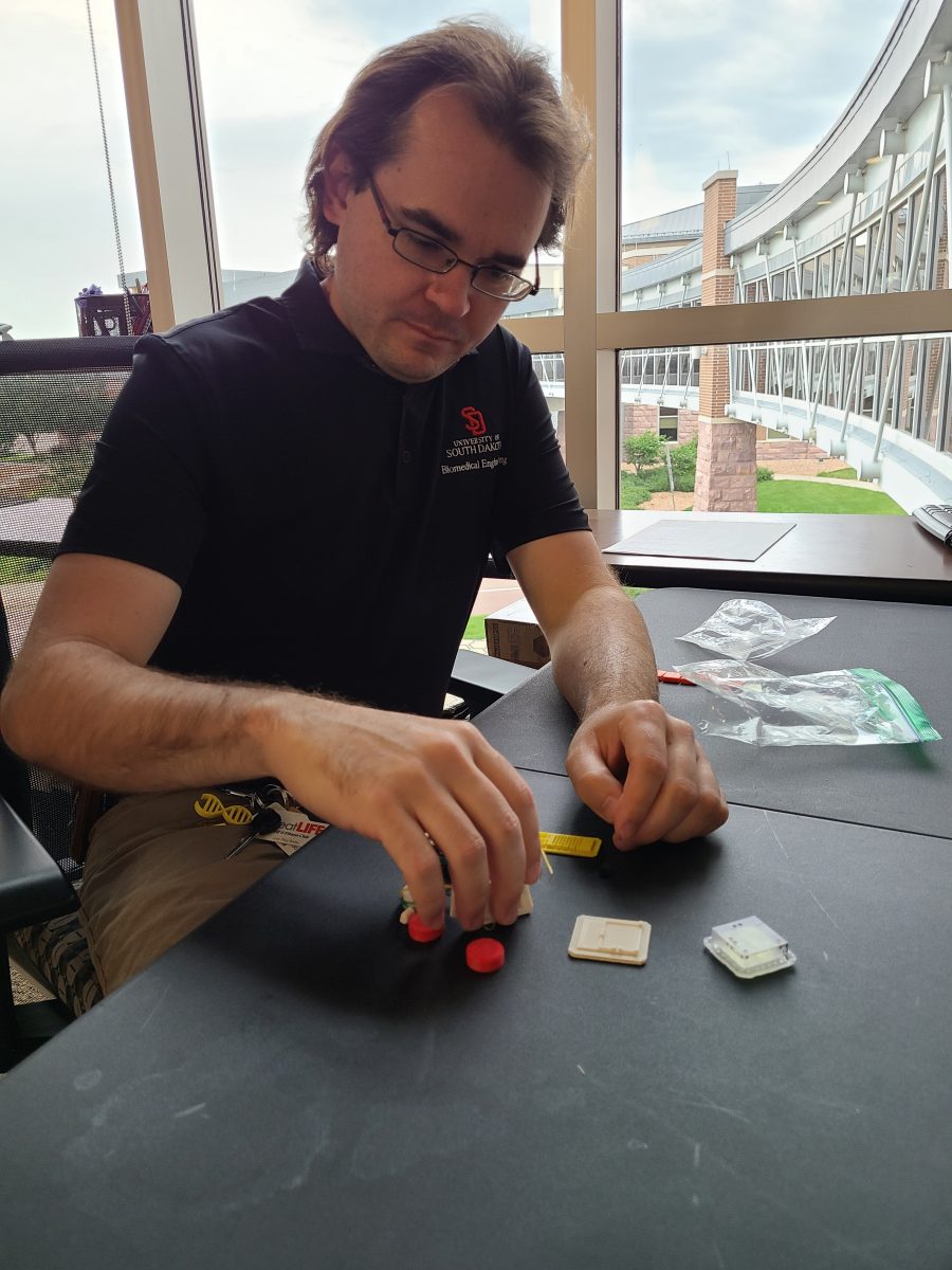 Tim Hartman examines structures he's helped 3D-print.